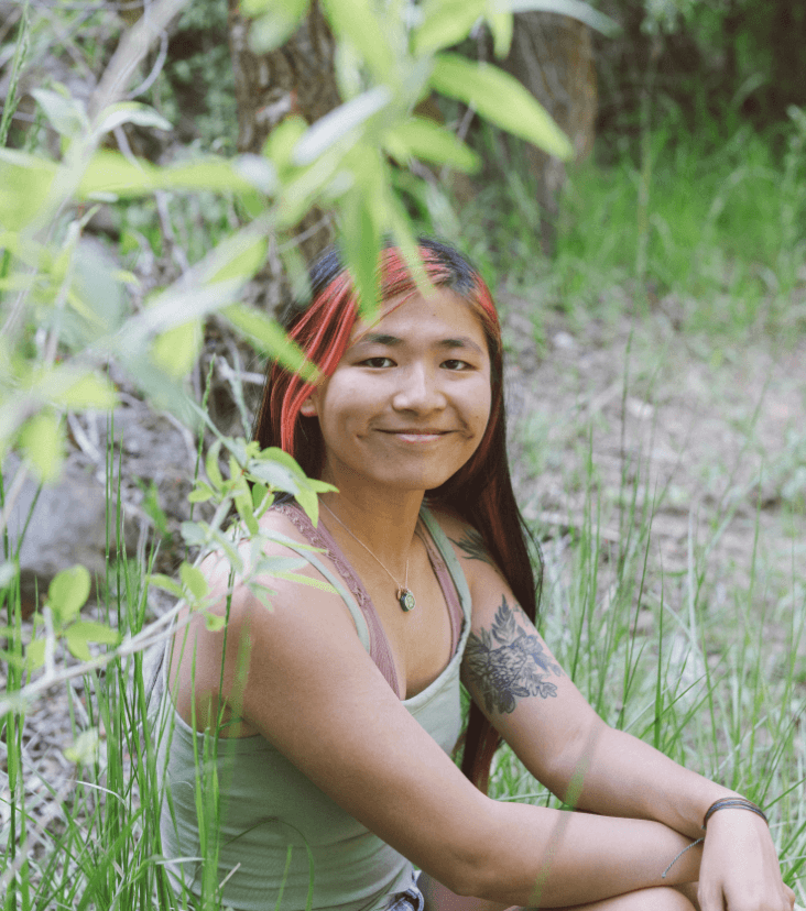 Niki DiGaetano sitting in a forest